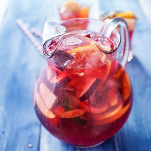 sangria pitcher with fruits on table top